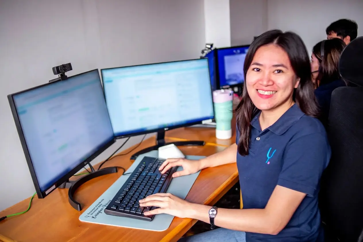 Professional Filipino BPO worker smiling at desk