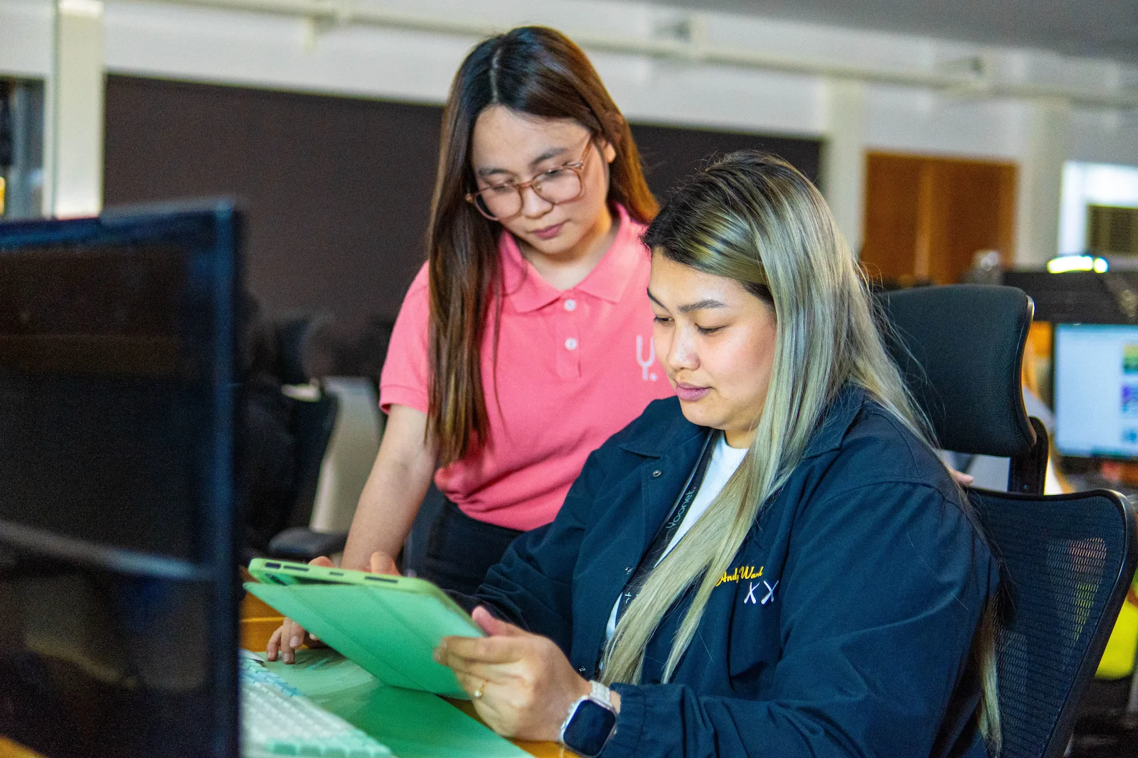 Two Yoonet team members collaborating at a desk