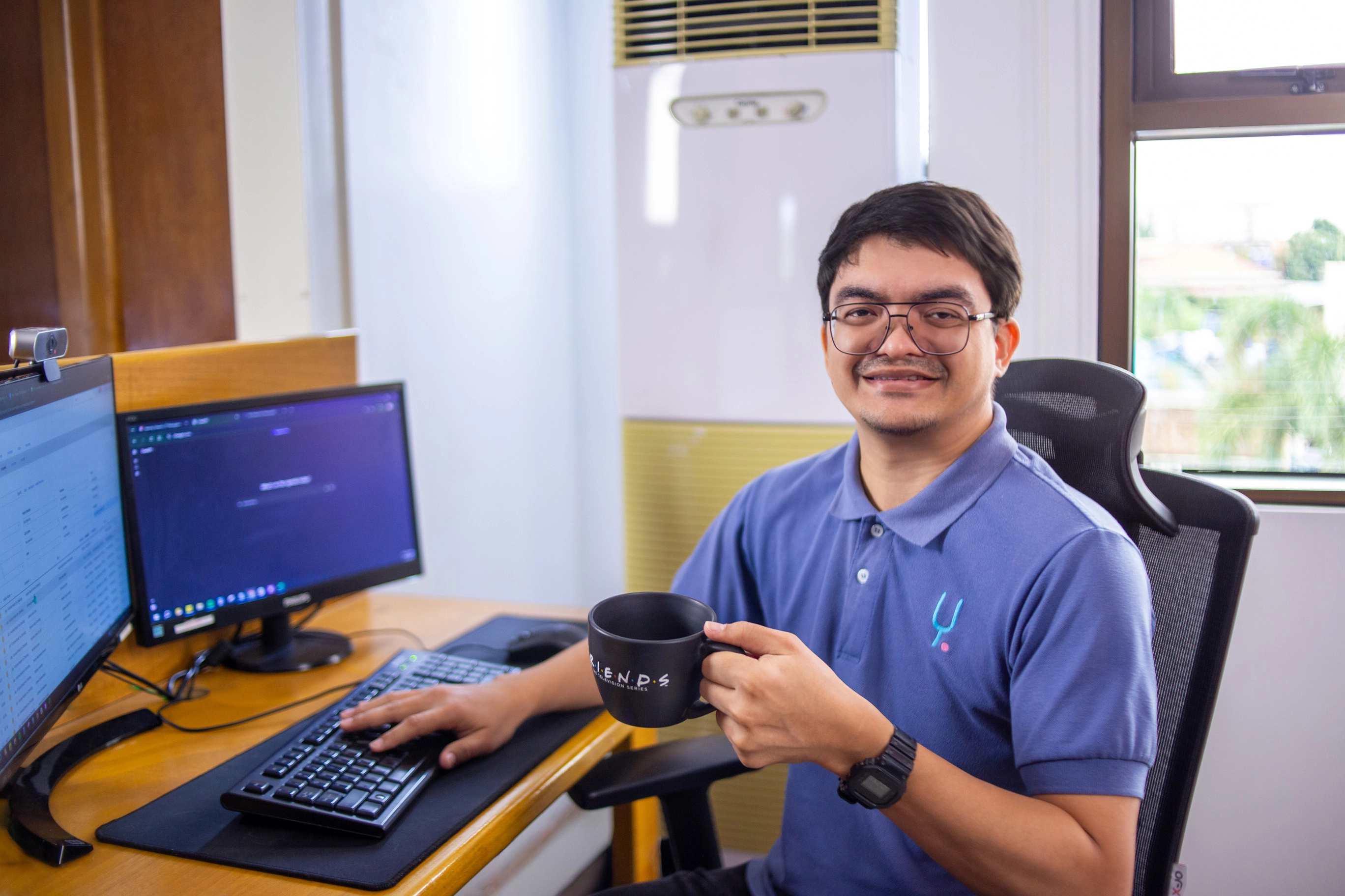 Professional Filipino BPO worker smiling at desk